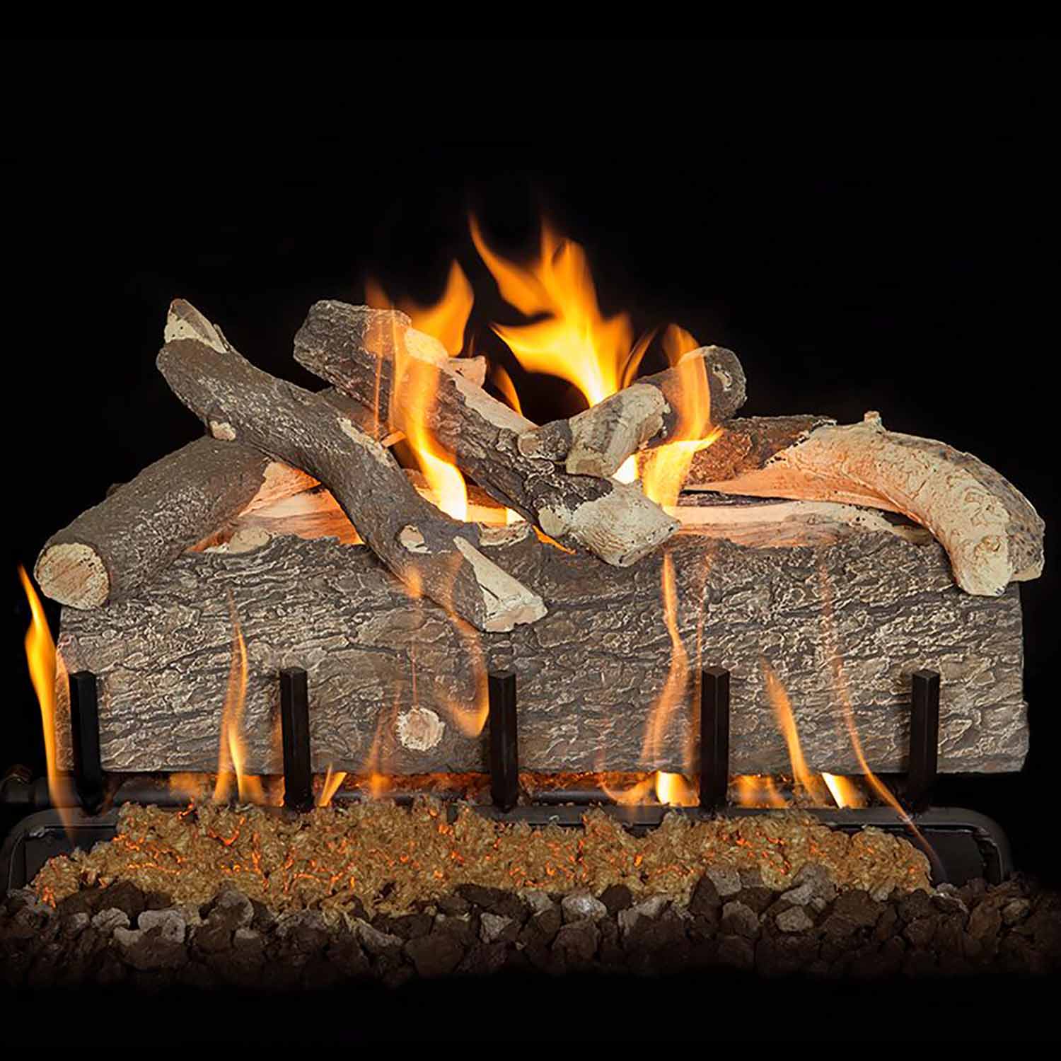 Gas log set with split pine logs and bright orange flames over a burner base