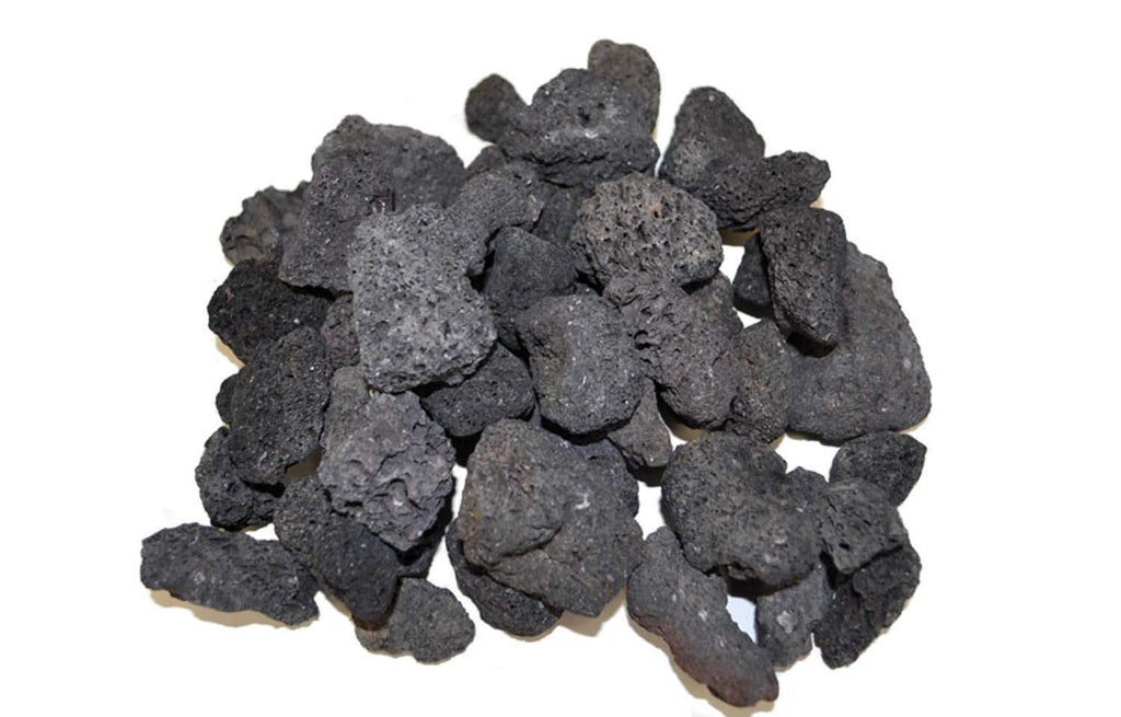 Black lava rock for fire pits, assorted irregular stones in a loose pile