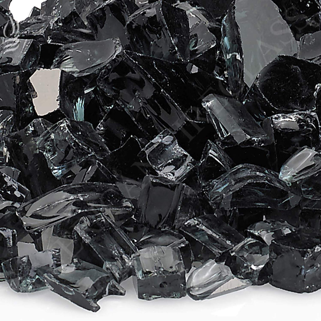 Close-up of black reflective fire glass shards with glossy facets
