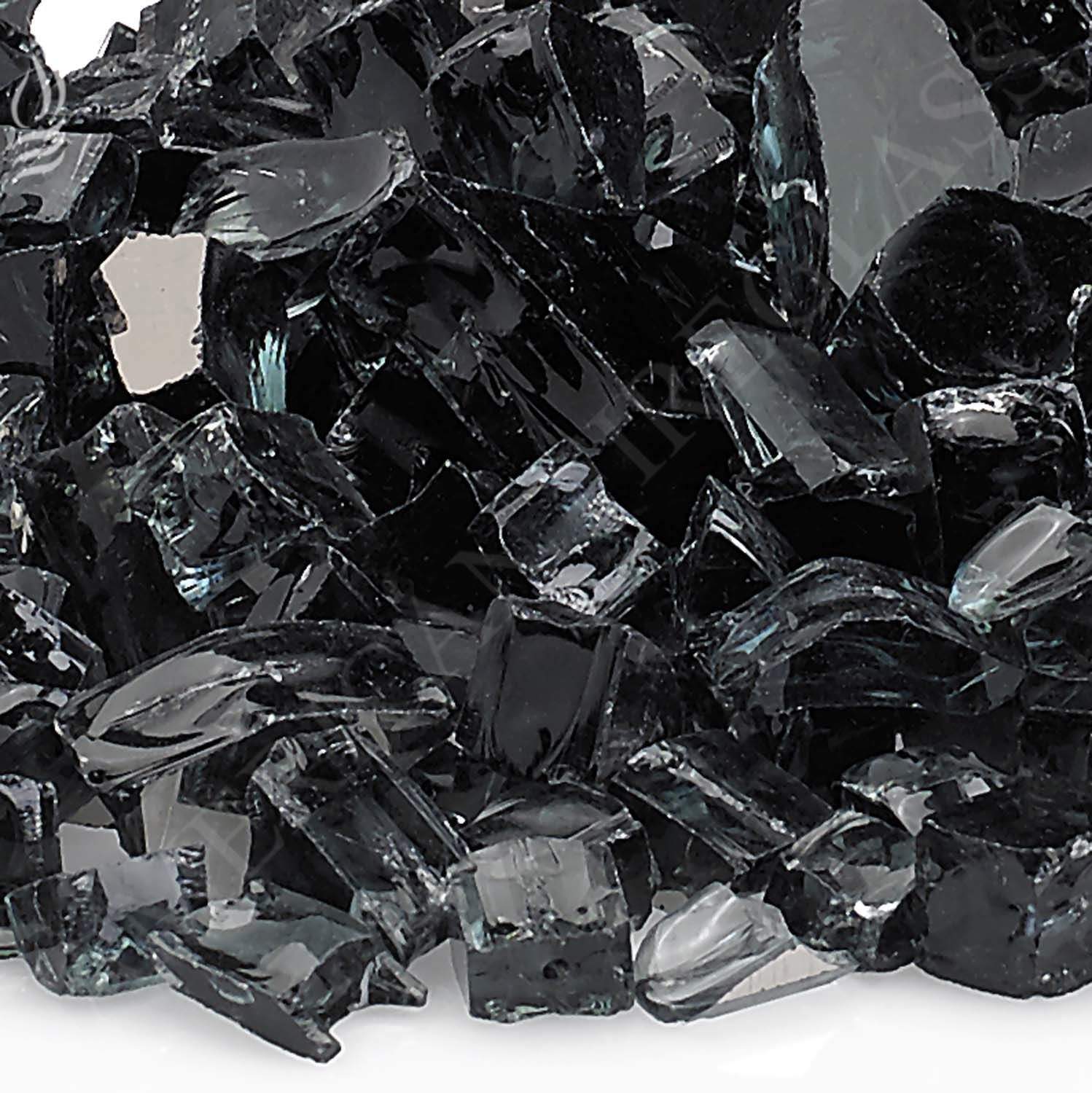 Close-up of black reflective fire glass shards with glossy facets