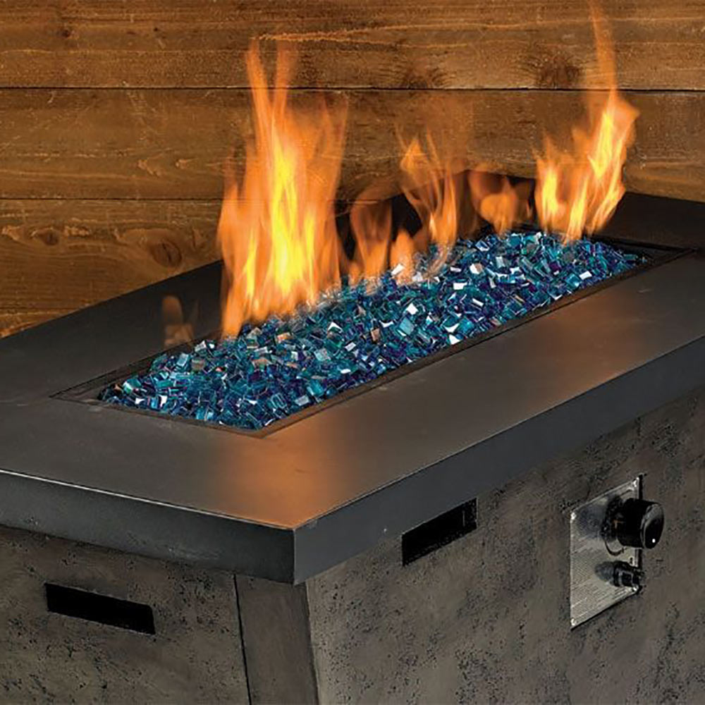 Pacific blue glass fire beads in a metal fire pit tray with flames