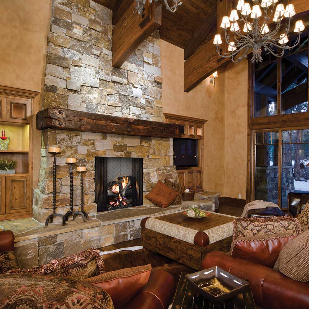 Radiant wood burning fireplace with stone surround and wood mantel, viewed in room