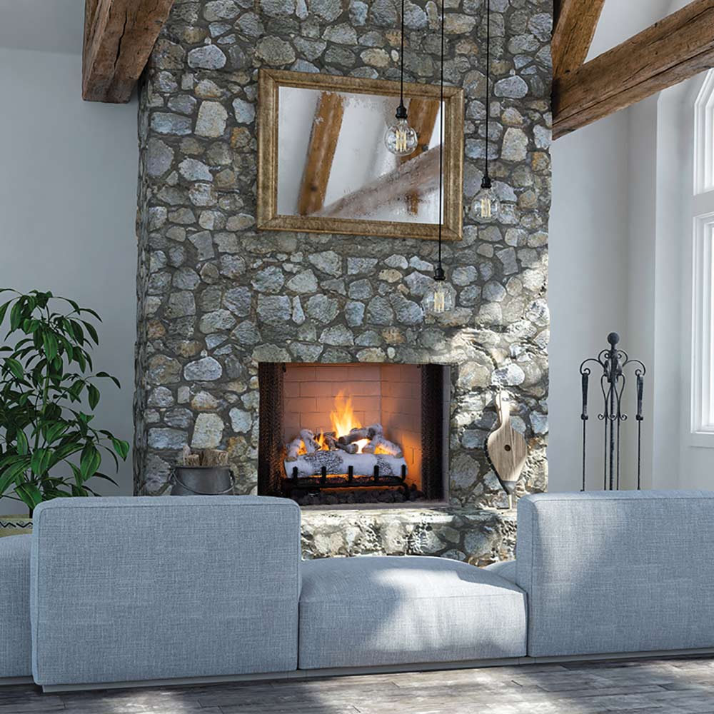 Gas fireplace with white birch ceramic fiber logs burning inside stone surround