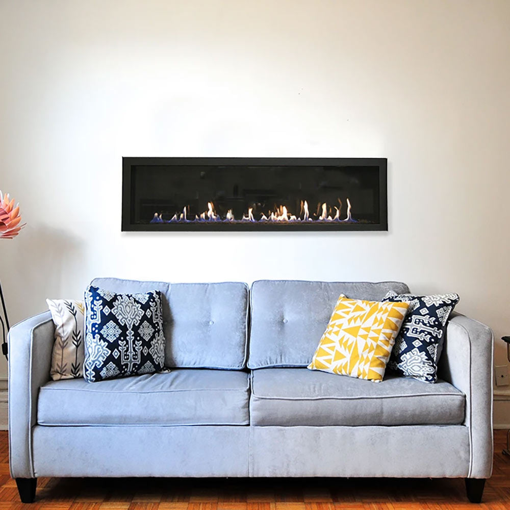 Wall-mounted linear gas fireplace in black frame with flames burning on fireglass