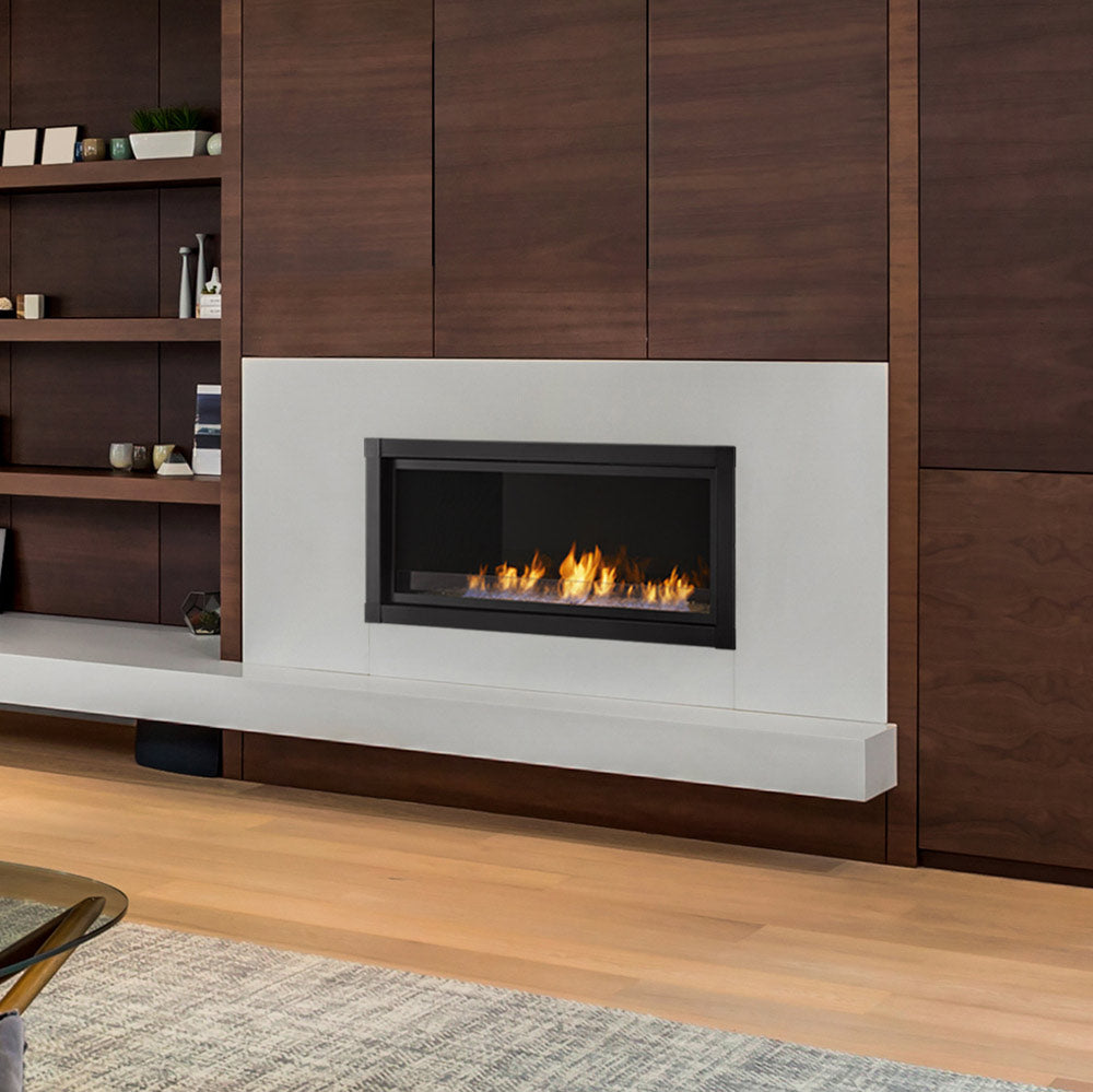 Vent-free gas fireplace with dark inset and white surround, burning flames