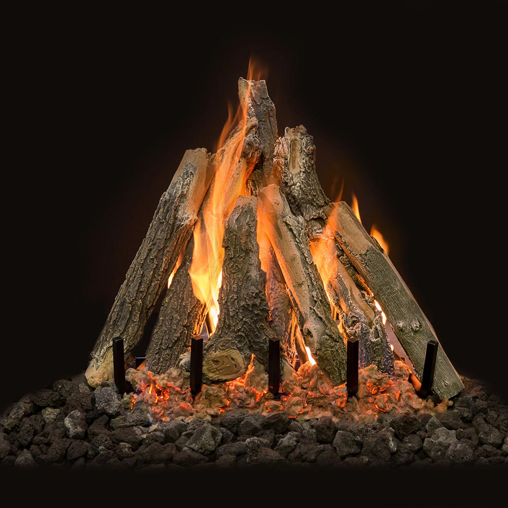 Vented gas log set with burning faux logs and black grate over coal bed