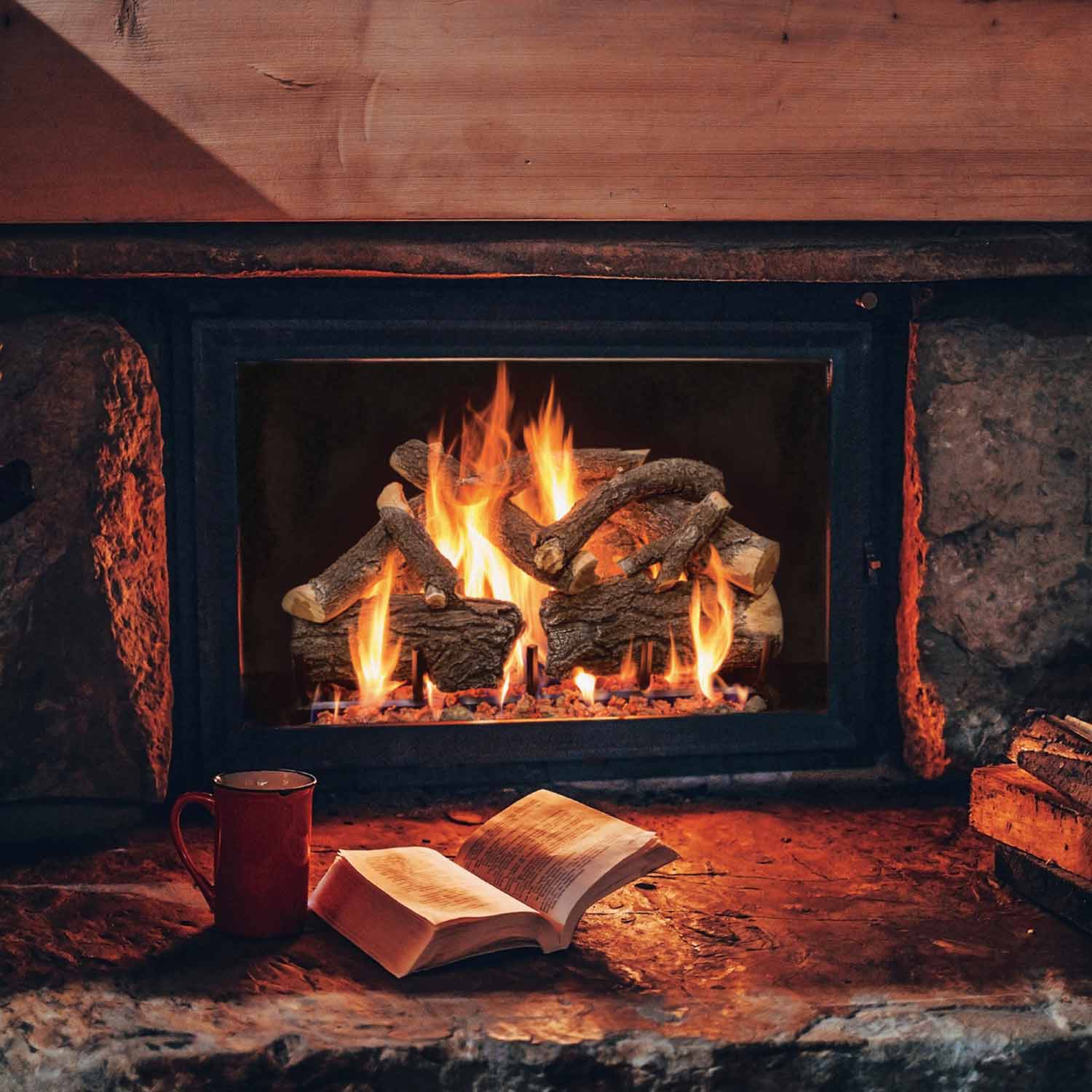 Charred log set burning inside a rectangular firebox, with flames and embers.