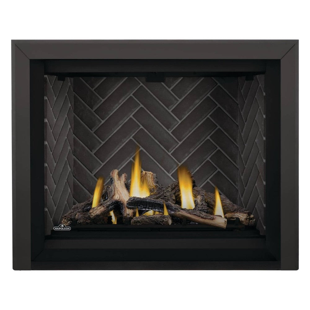 Black direct vent gas fireplace with burning logs and flames against brick-pattern backing