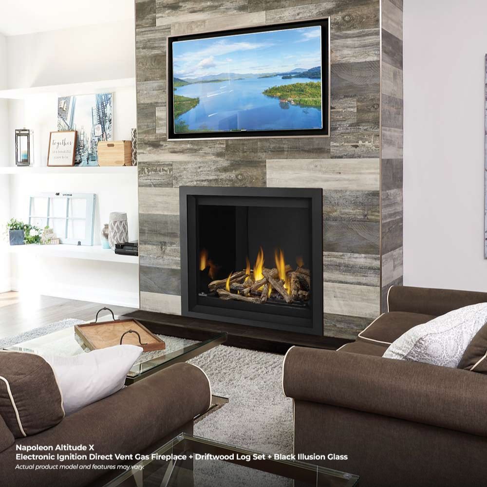 Black direct vent gas fireplace set into a stone wall surround with flames visible