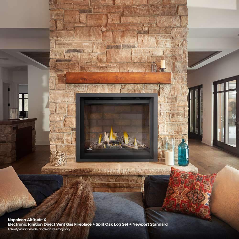 Direct vent gas fireplace with flames in a dark framed firebox within a stone surround