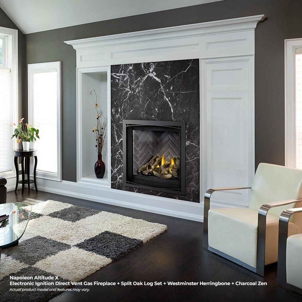 Black direct vent gas fireplace set in marble-look surround with flames visible in firebox