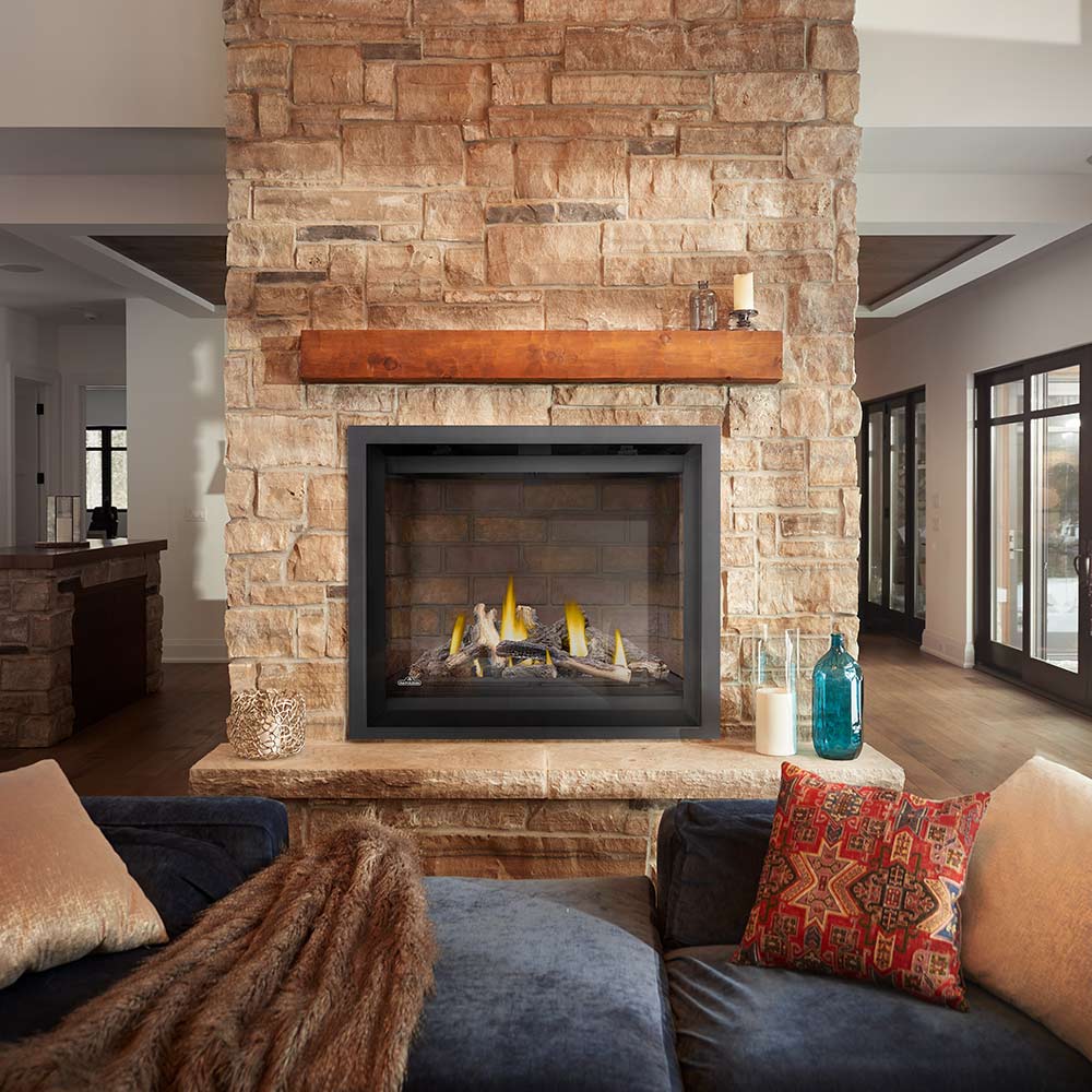 Gas fireplace with black frame and stone surround, burning logs in view