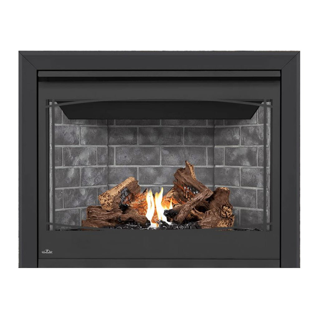 Direct vent gas fireplace with black surround, burning logs, and flames behind gray brick.