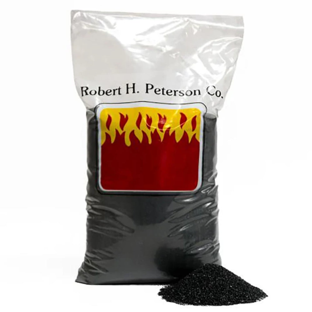 Bag of black sand with a small pile of sand on the side