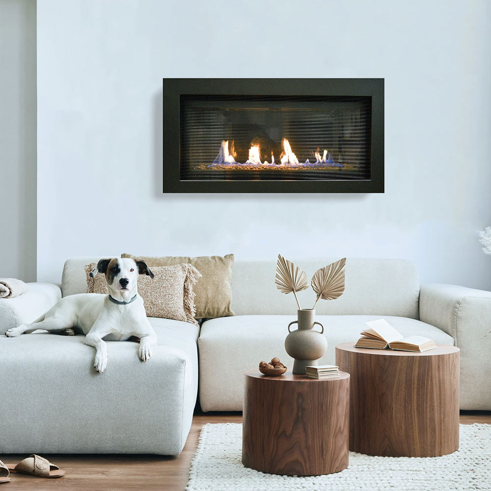 Built-in linear gas fireplace with dark frame, glass front, and flames over fireglass