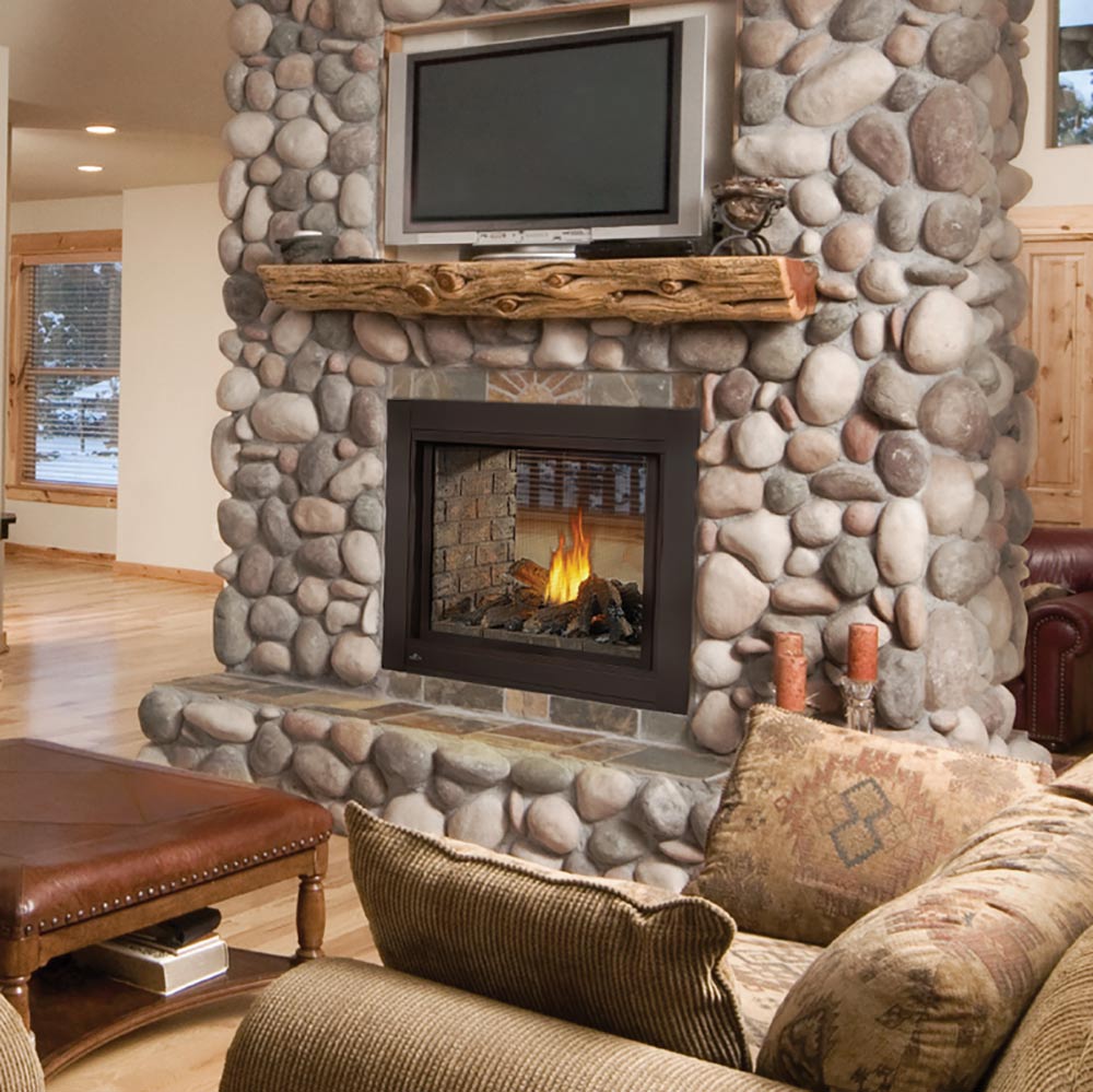 Inset gas fireplace with visible flame set in a decorative stone wall surround