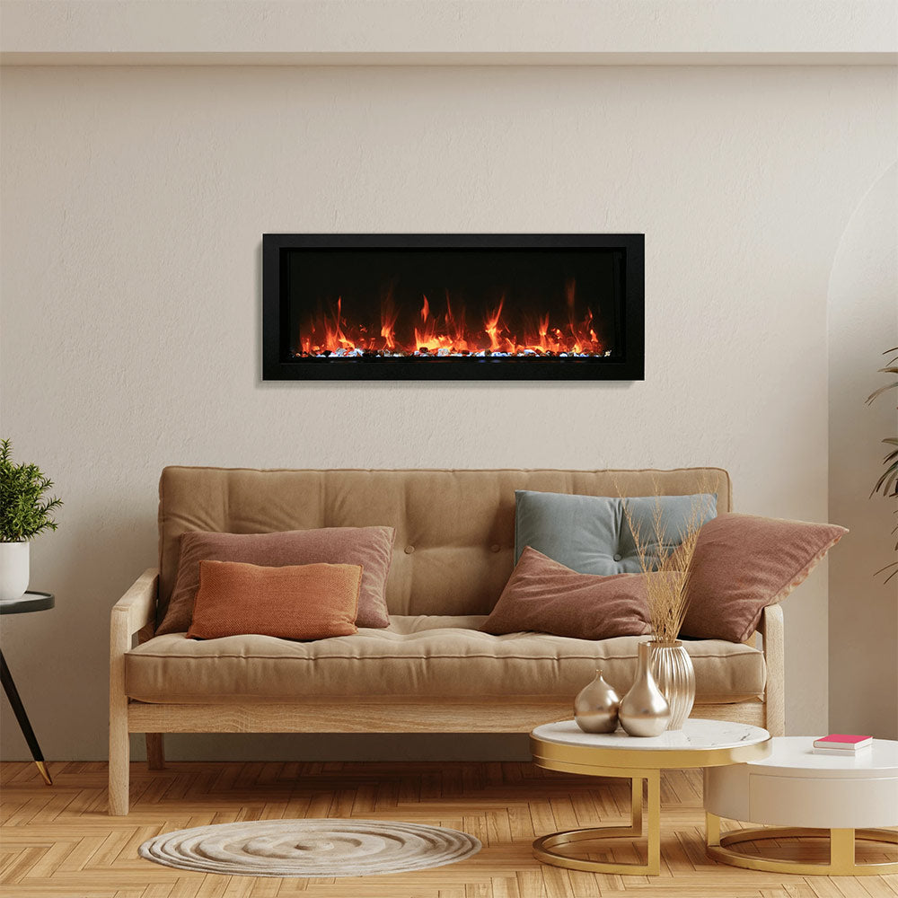 Slim electric fireplace with black frame mounted on wall and orange flame effect