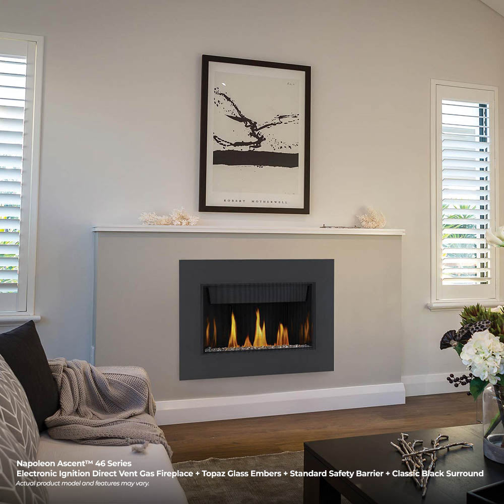Wall-mounted linear gas fireplace with flame bed and black surround