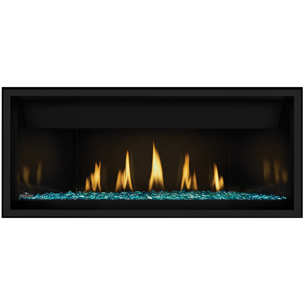 Direct vent gas fireplace with glowing orange flames and turquoise glass embers base