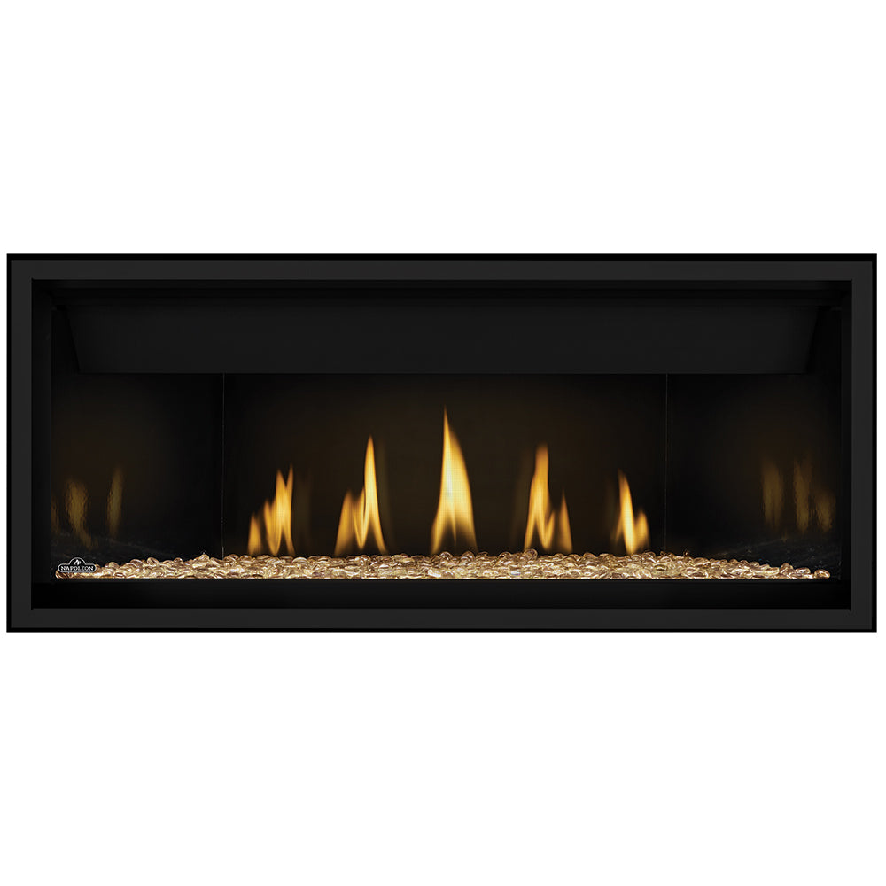 Direct vent gas fireplace with glowing orange flames and amber gold glass embers base