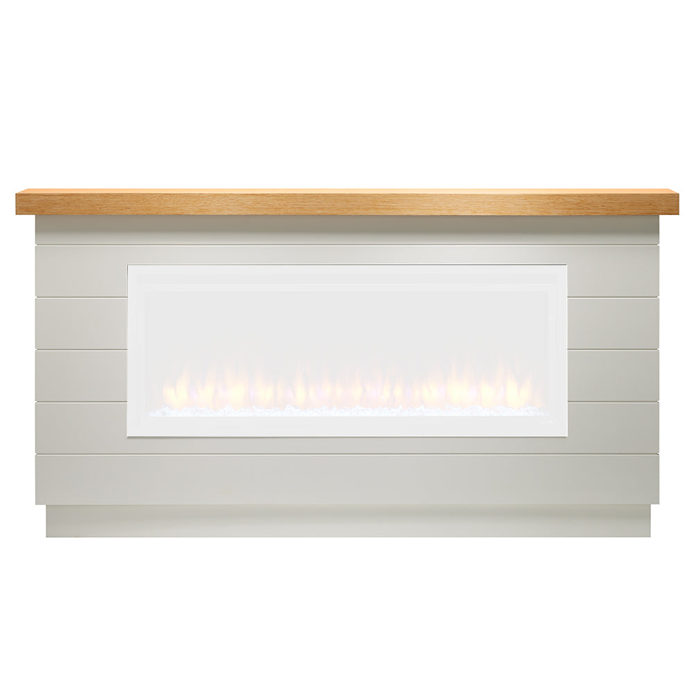 Electric fireplace mantel package with light gray surround and wood top, glowing flames