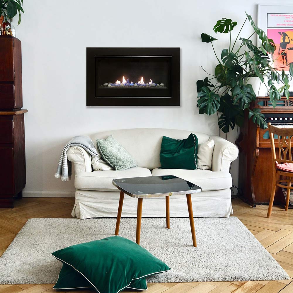 Black built-in gas fireplace with glowing flame and pebble fire media