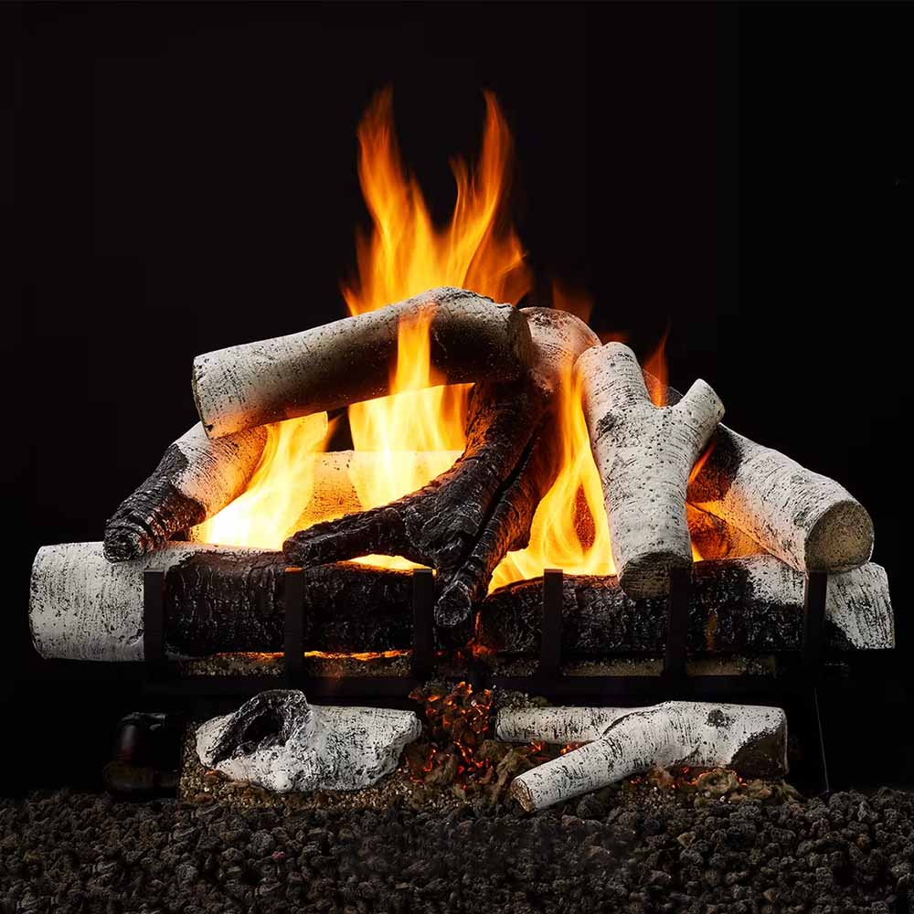 Vented indoor gas log set with stacked birch-style logs and bright flames