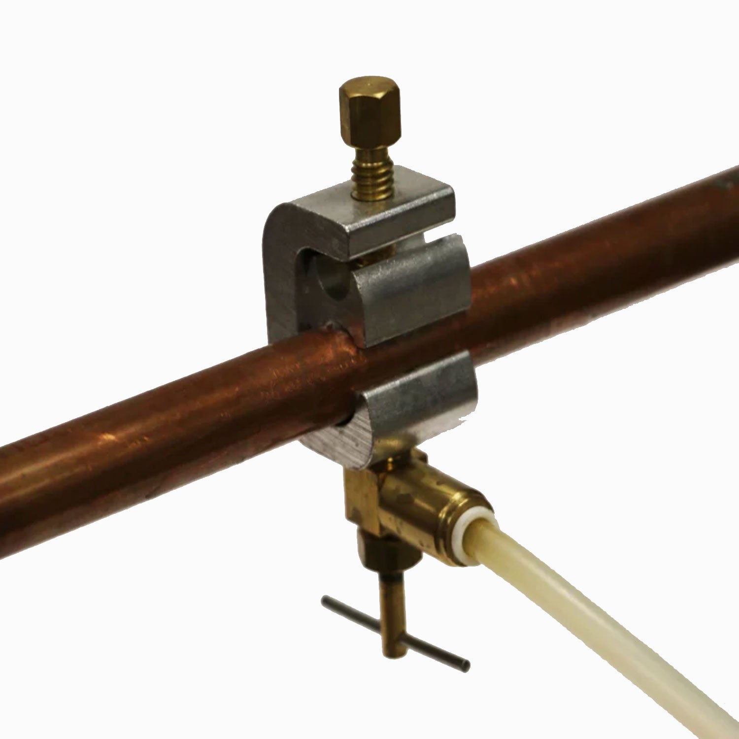 Plumbing kit fitting with brass valve on dark copper pipe and white tubing