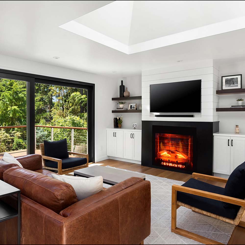 Black built-in electric fireplace insert with lit flame in front opening