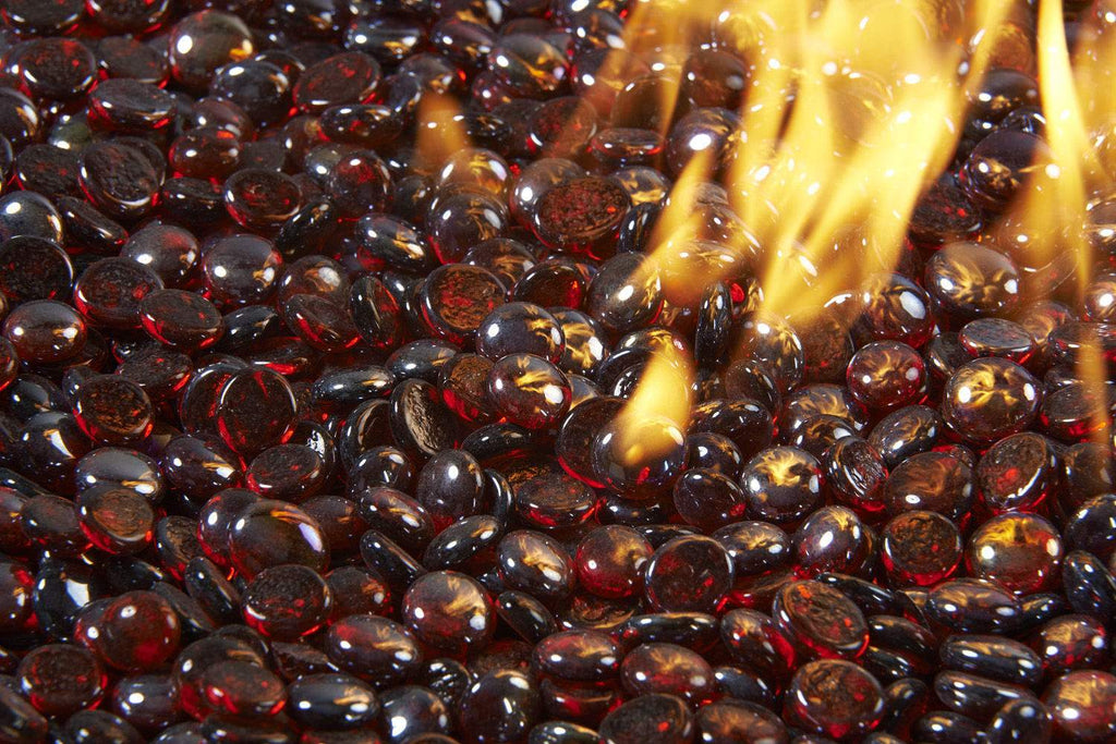 Ruby red fire glass gems with a glowing flame passing over the stones