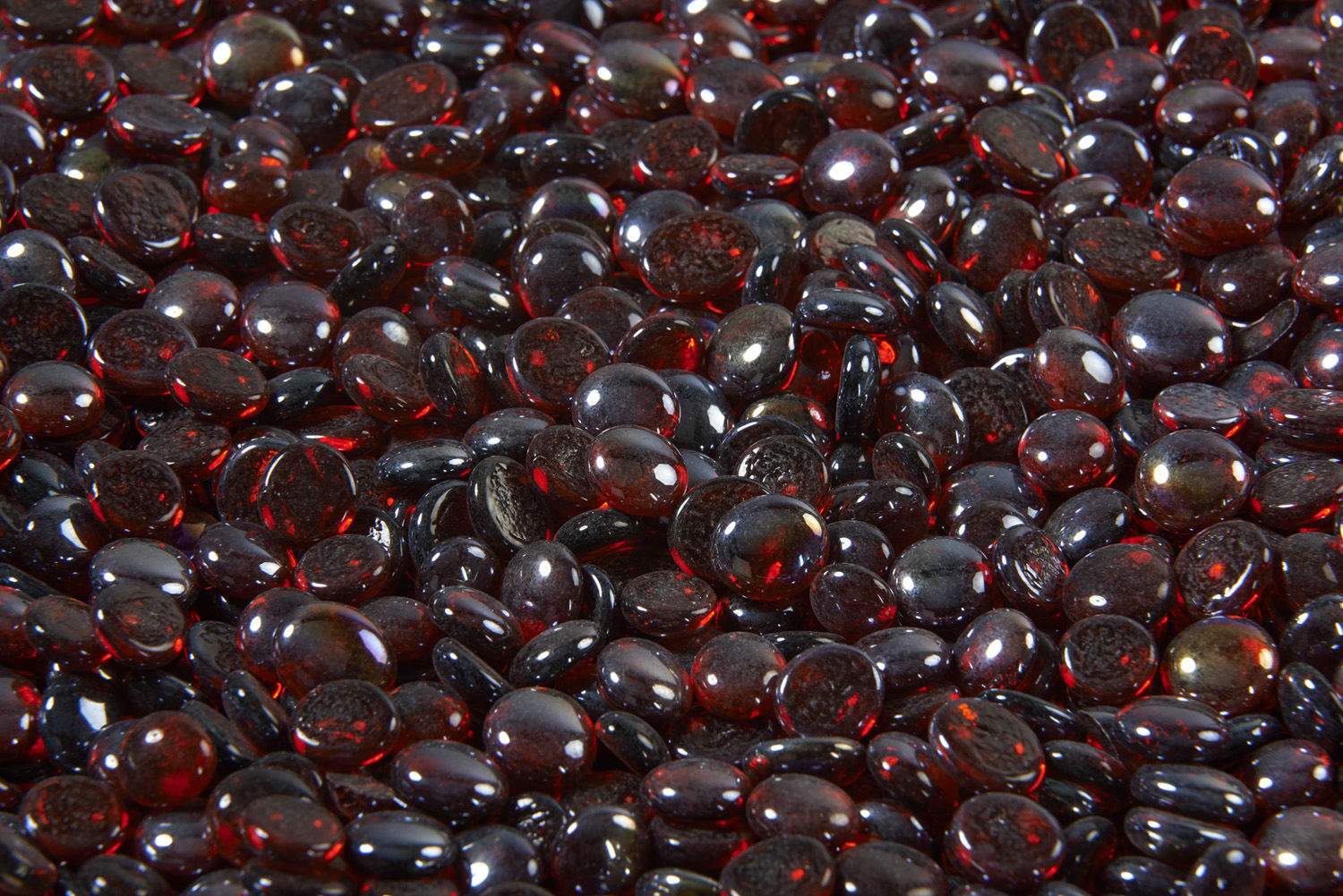 Ruby red crystal fire glass gems, rounded glass beads in a close-up pile