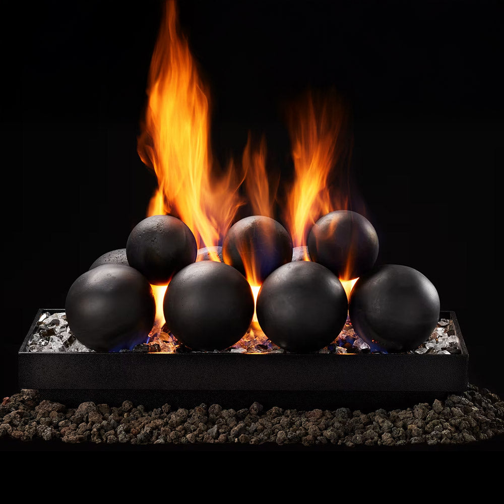 Indoor gas burner with black cannonball media and visible flames