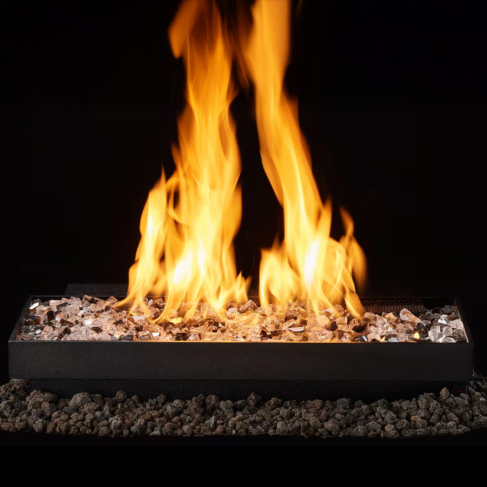 Indoor vented gas burner with burning flames over crushed glass embers