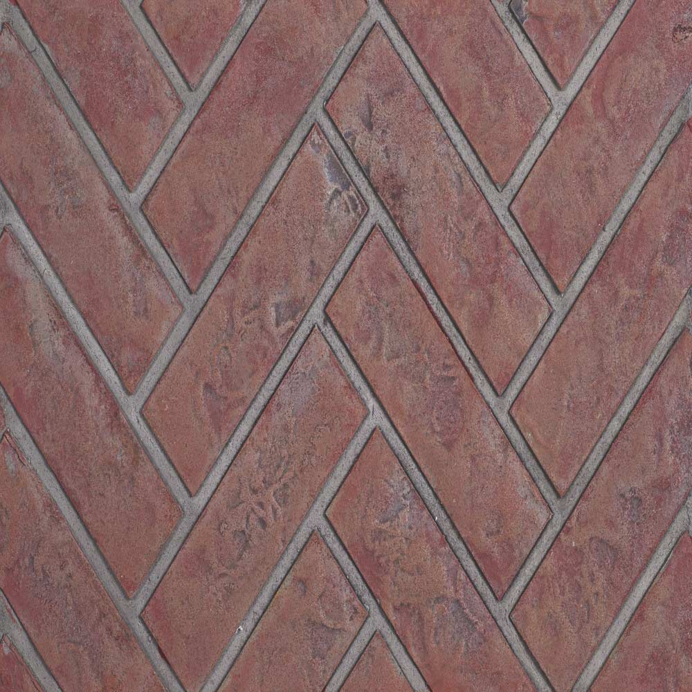 Decorative brick fireplace panel with red herringbone blocks and grey mortar lines