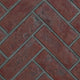 Decorative brick panel in red with herringbone pattern and gray mortar lines