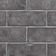 Decorative brick panel in dark gray with rectangular blocks and mortar lines
