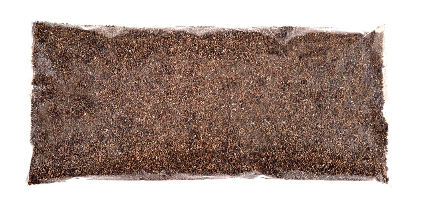 Vermiculite mineral board with dark brown granular texture
