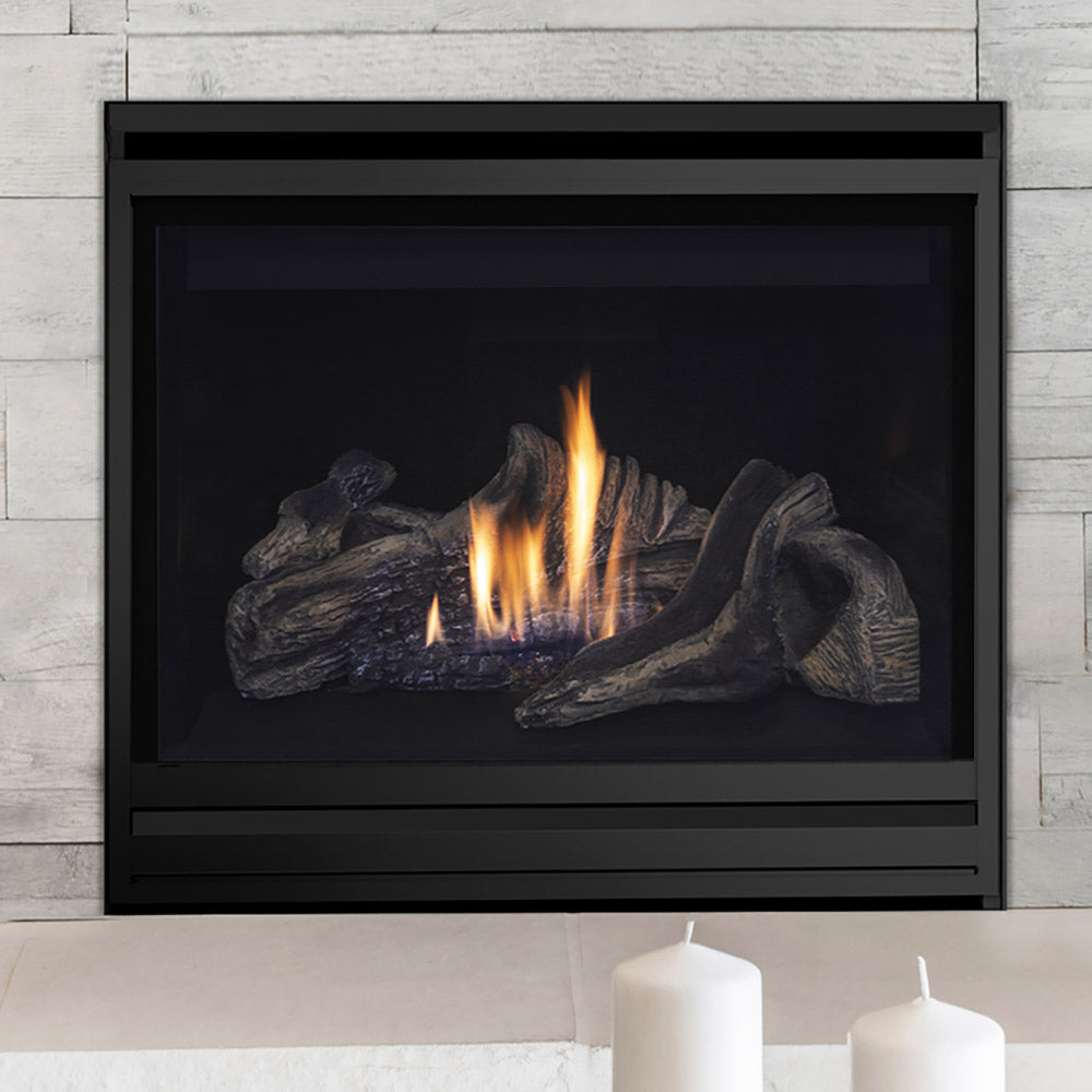 Black direct vent gas fireplace with gray log set and tall flames through glass