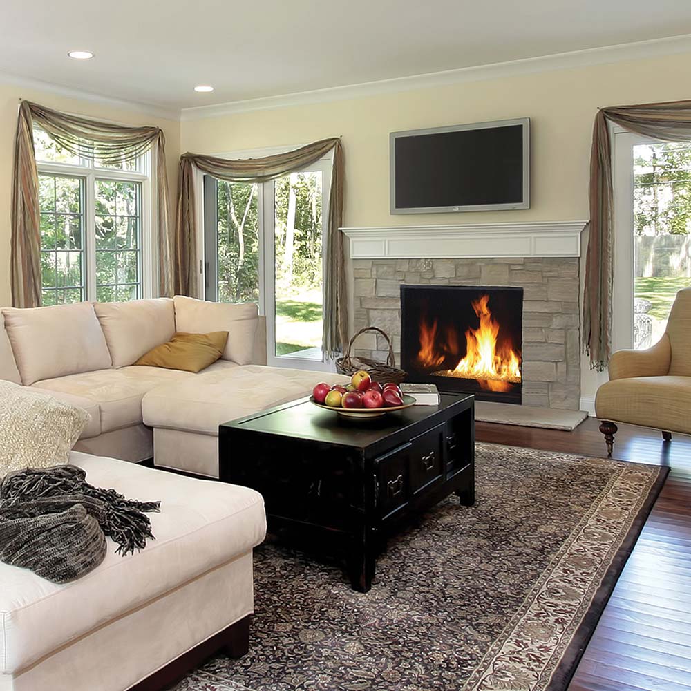 Direct vent gas fireplace installed in living room with visible flames behind glass