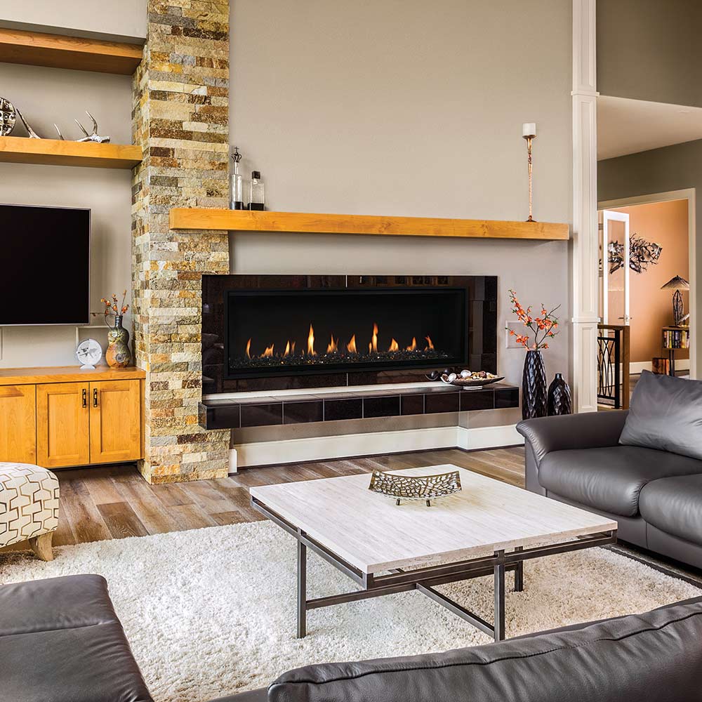Black framed gas fireplace with glowing flames and crushed glass media