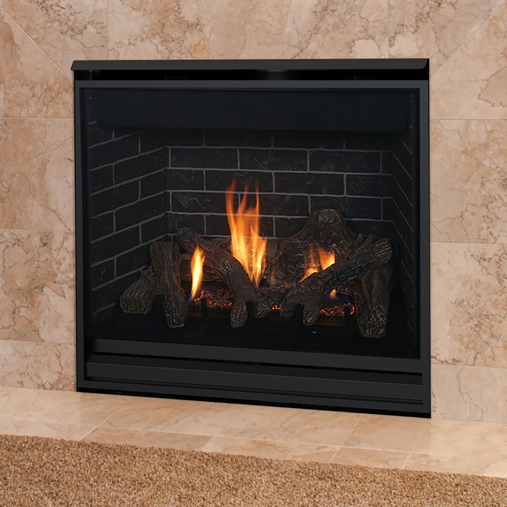 Black direct vent gas fireplace set in a stone wall with burning flames and logs