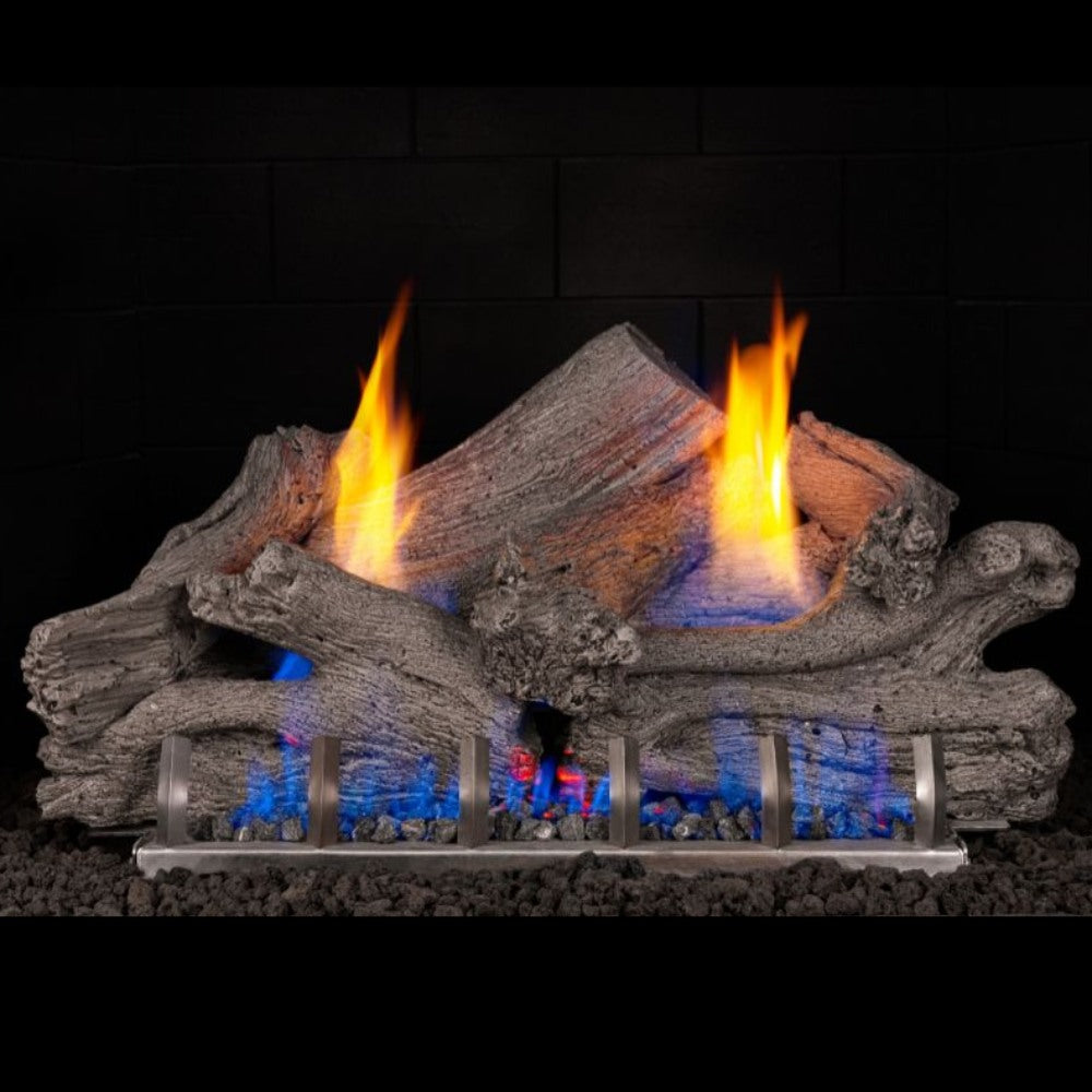 Real Fyre ventless outdoor gas log set with gray driftwood logs and blue flame bed