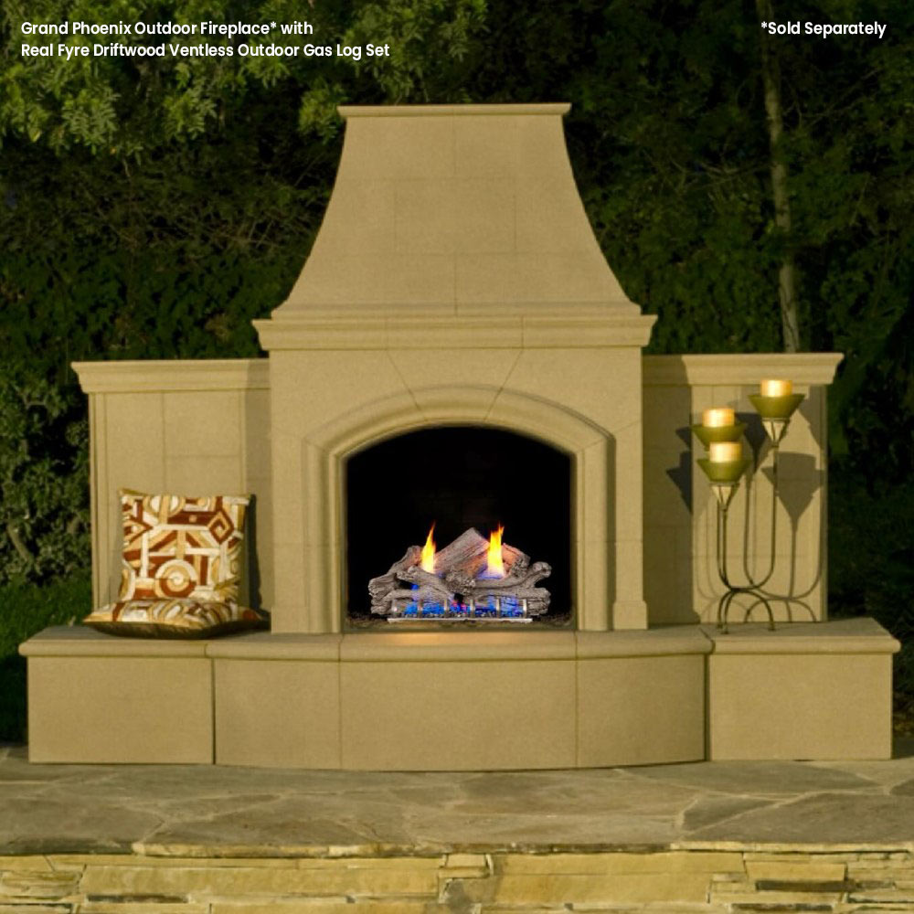 Outdoor ventless gas log fireplace with gray driftwood logs and small flames