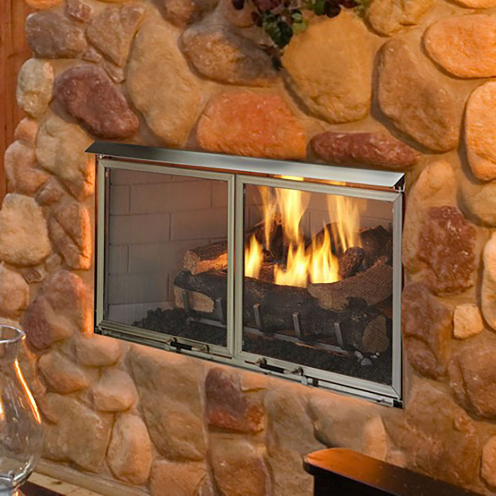Stainless steel fireplace screen doors with two mesh panels, flames visible behind