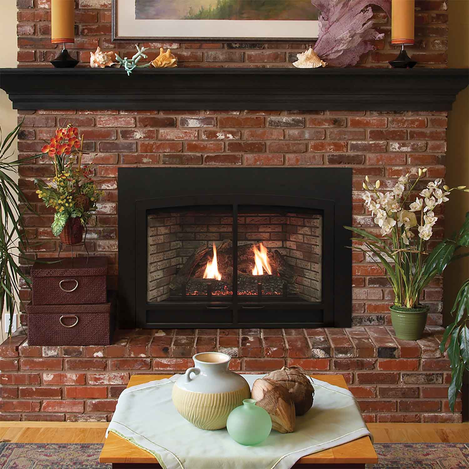 Black fireplace insert with two flames in a brick opening