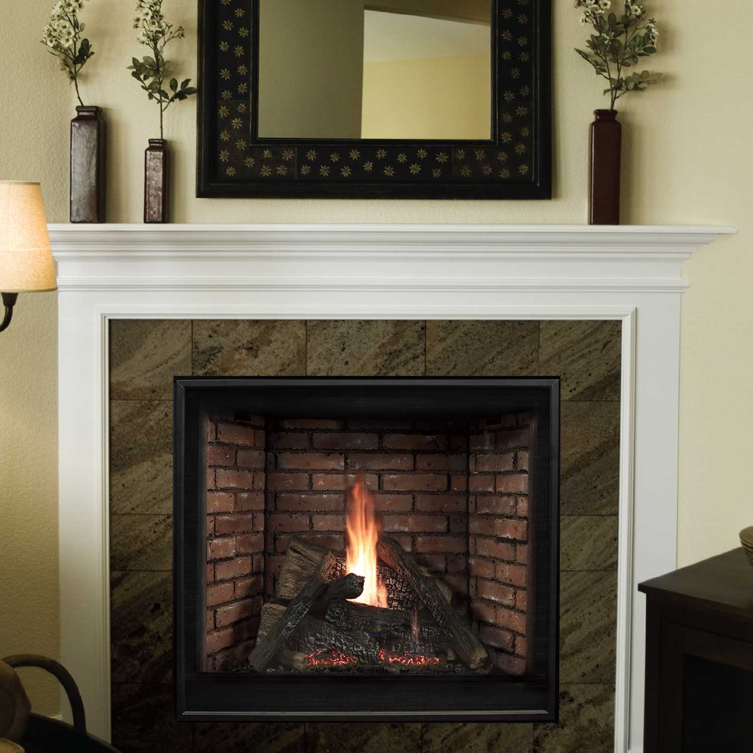 Gas fireplace insert with brick-pattern interior and black trim, shown in wall opening