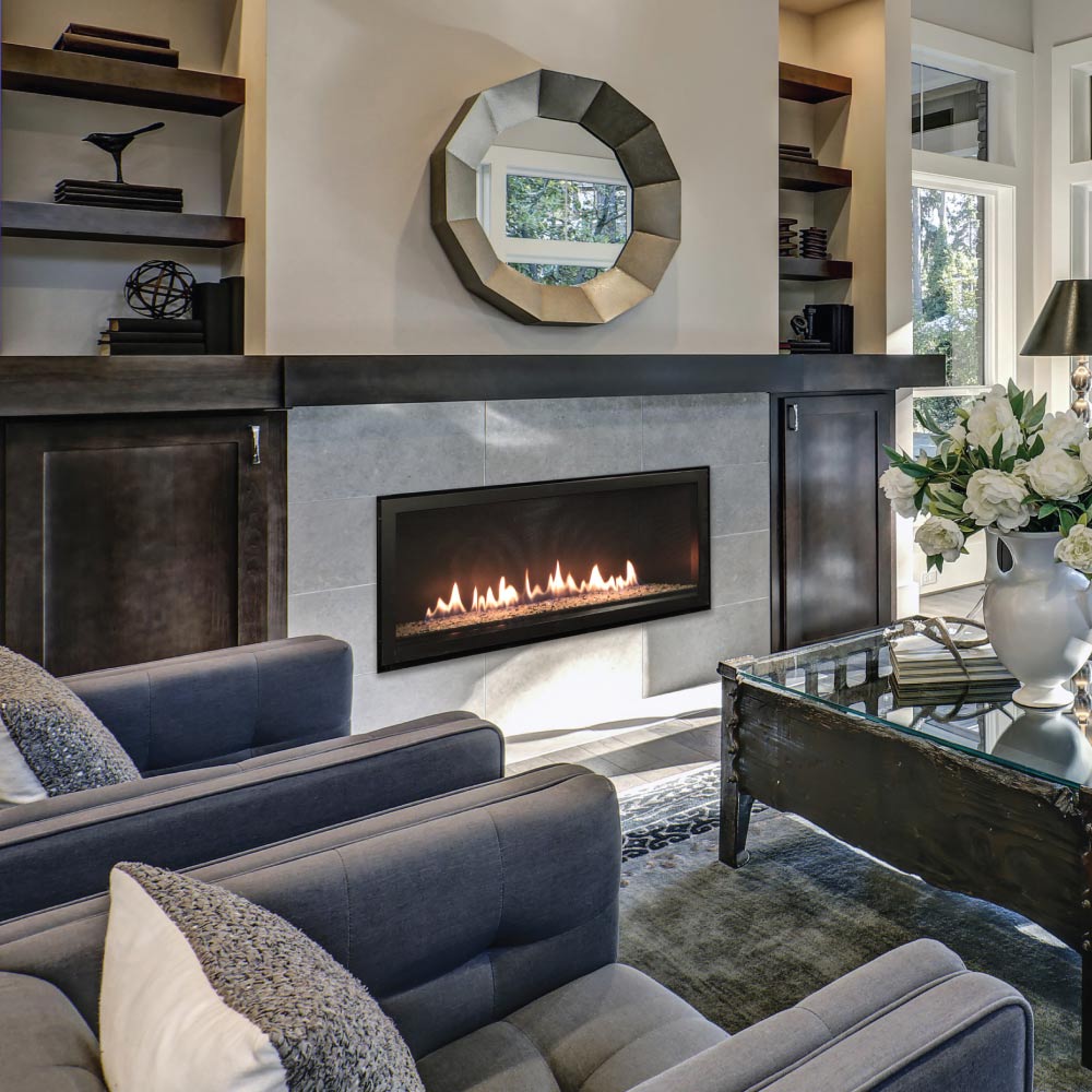 Wall-mounted linear gas fireplace with black surround, flame window