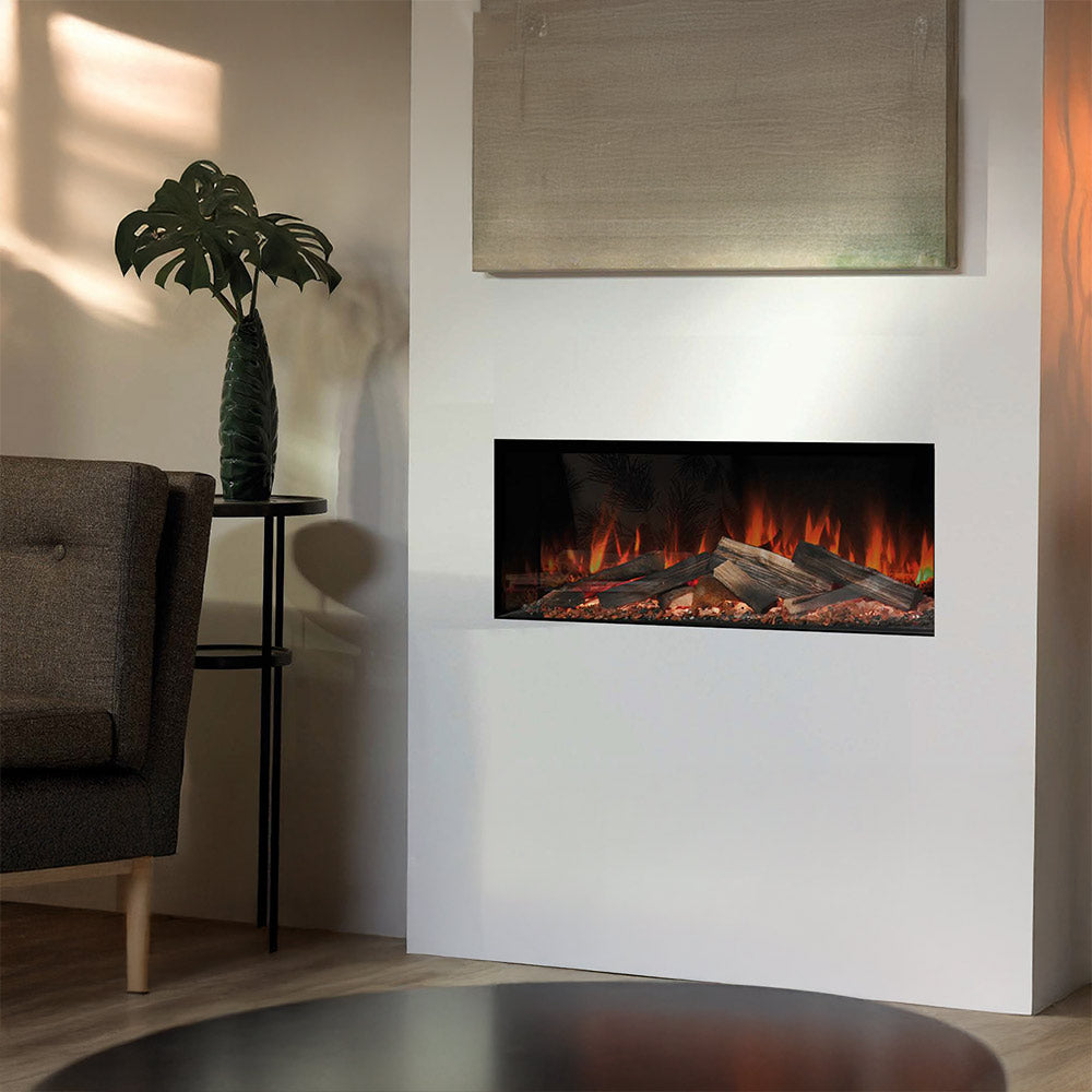 Linear electric fireplace with black frame and glowing flame log bed