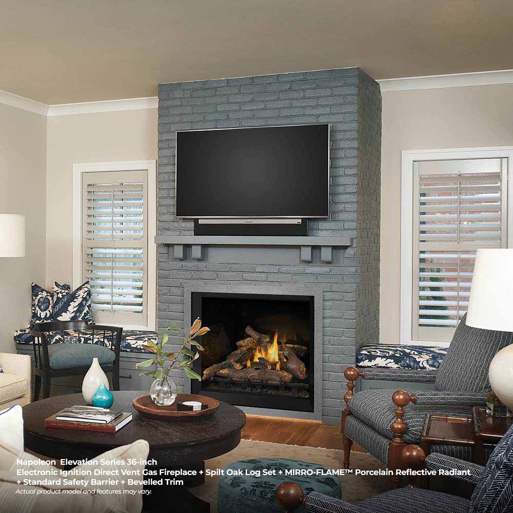 Direct vent gas fireplace with black glass front, gray brick surround, and flames