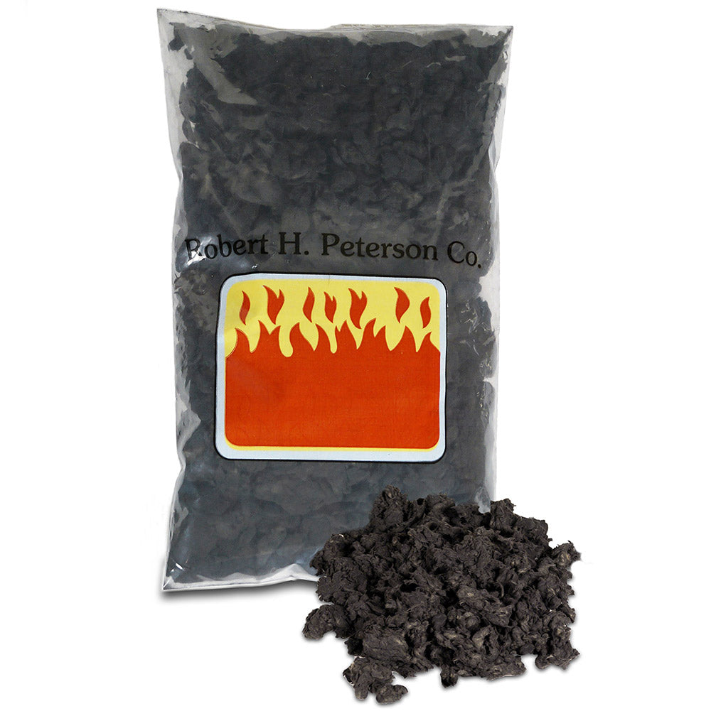 Bag of black embers for fire, with Real Fyre label and loose charcoal pieces